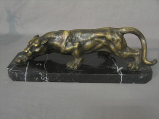 A reproduction figure of a walking Jaguar, raised on a marble base 17"