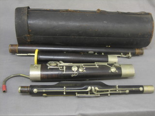 A 4 piece wooden Bassoon by Alder & Co marked Sole Agents for Great Britain Joseph Higham Ltd, Manchester HP, contained in a leather carrying case
