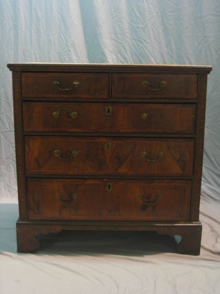 A Queen Anne oak and walnut chest of 2 short and 3 long drawers, with brass escutcheons and swan neck drop handles, raised on bracket feet 37"
