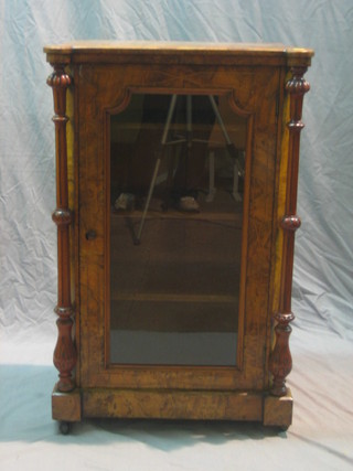 A Victorian inlaid figured walnut music cabinet, the interior fitted shelves enclosed by a glazed panelled door flanked by a pair of fluted columns 22"