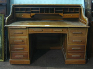 A Victorian bleached oak roll top desk with various pigeon holes (requires some attention) 58"