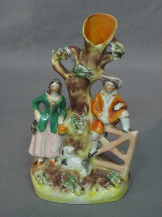 A 19th Century Staffordshire arbour spill vase in the form of a tree stump, lady, gentleman and dog 6"