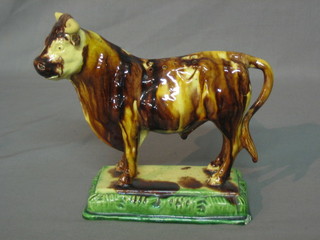 A Staffordshire figure of a standing bull, the base with illegible impressed mark (tail f and r) 7"
