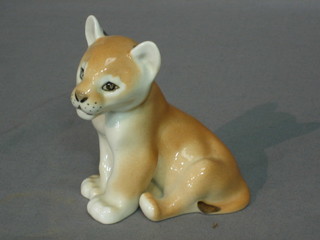 A Soviet Russian porcelain figure of a seated panda 5" and a porcelain figure of a seated lion cub 3", unmarked
