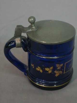 A 19th Century Bristol blue glass stein with gilt painted decoration marked Gwenhe Mein, with pewter lid 3 1/2"