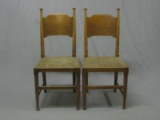 A set of 6 Art Nouveau oak dining chairs with shaped backs, raised on turned block supports, by William Birch