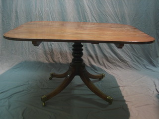 A 19th Century mahogany breakfast table, raised on pillar and tripod supports ending in brass caps and castors 51"
