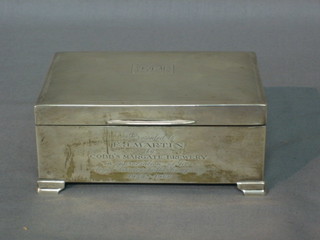 A silver cigarette case with engine turned decoration and hinged lid, raised on bracket feet, London (marks rubbed) 5"