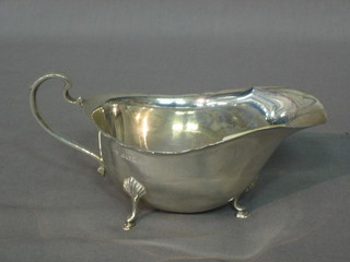 A modern silver sauce boat with wavy border, raised on 4 hoof feet, 2ozs
