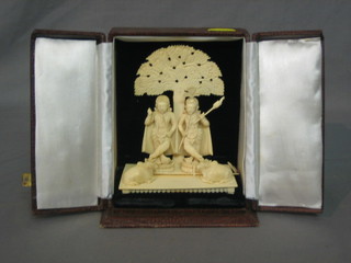 A carved ivory figure group of 2 standing warriors beneath an arbour with buffalo, 5 1/2", cased