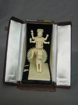 A carved ivory figure of a Deity on a mythical beast 7", cased