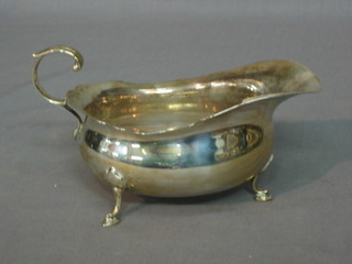 A Georgian style silver sauce boat with wavy border and C scroll handle, Birmingham 1932, 4 ozs