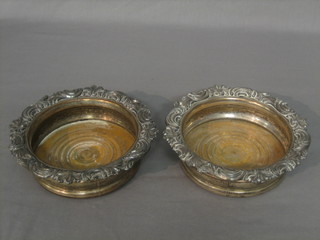 A pair of circular silver plated bottle coasters 6"