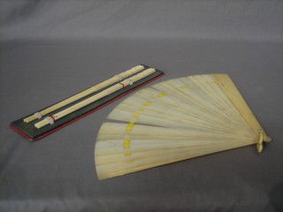 An ivory fan together with 2 pairs of ivory chop sticks