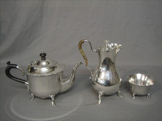 A circular silver plated 3 piece tea service comprising teapot, sugar bowl and hotwater jug, by Mappin & Webb