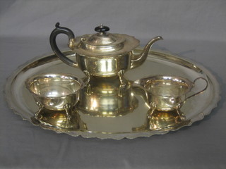 A silver plated 3 piece tea service of oval form with teapot, sugar bowl and milk jug, together with a matching tray