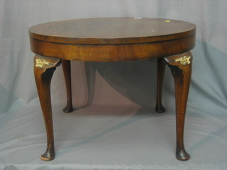 A circular Art Deco walnut occasional table raised on cabriole supports 24"