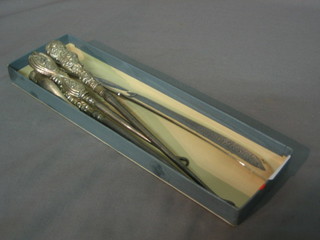 A silver handled shoe horn and 3 button hooks