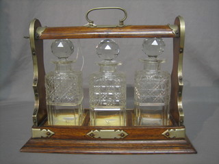 An oak and silver plated 3 bottle tantalus