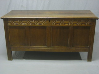 An 18th Century carved oak coffer with panelled construction with hinged lid 59"