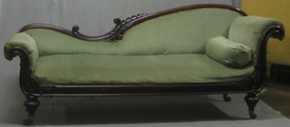 An early Victorian mahogany show frame sofa upholstered in green material, raised on turned supports 82"