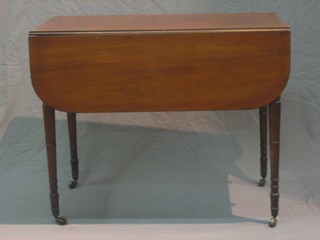 A 19th Century mahogany Pembroke table fitted a drawer raised on ring turned supports ending in brass caps and castors 35"