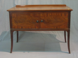 An Edwardian mahogany wash stand with raised back, enclosed by inlaid panelled doors, raised on outswept supports 40"
