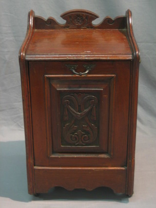 An Edwardian carved walnut coal purdonium with three-quarter gallery and brass handles to the sides 15"