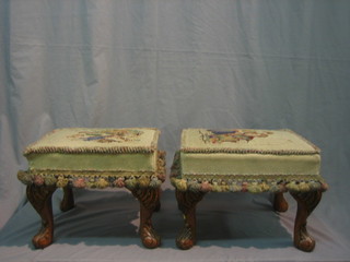 A pair of walnut rectangular stools with Berlin wool work seats, raised on carved cabriole supports 14"