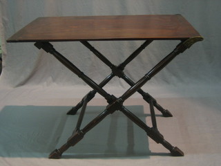 A mahogany folding table, raised on turned and block supports 36"