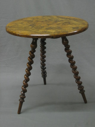 A Victorian circular figured walnut gypsy table raised on spiral turned supports 23"