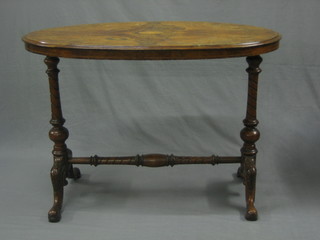 A Victorian oval figured walnut stretcher table with shell inlaid motif to the centre, raised on turned supports 41"