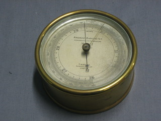 An aneroid barometer by T Wheeler Scientific Instrument makers with silvered dial and contained in a circular brass case 4 1/2"