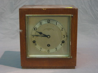 A 1930's Art Deco mantel clock with square silvered dial and Arabic numerals contained in an oak case by the Goldsmiths and Silversmiths Company