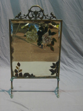 A Victorian brass fire screen containing a bevelled plate mirrored panel painted roses 33"