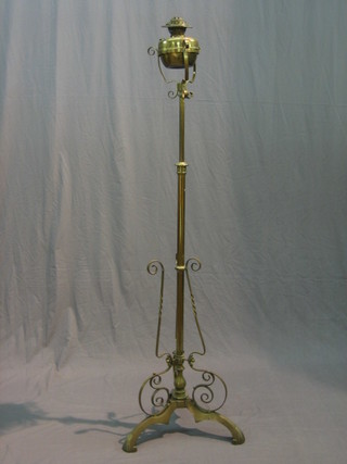 A Victorian brass adjustable oil lamp complete with reservoir