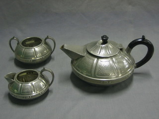 A 3 piece Craftsman planished pewter tea service with teapot, twin handled sugar bowl and cream jug