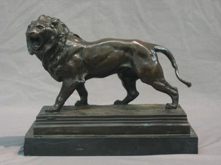 A reproduction bronze figure of a walking lion, raised on marble base 10"