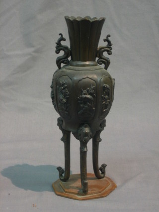 An Oriental bronze twin handled urn, raised on 3 scrolled supports 10"