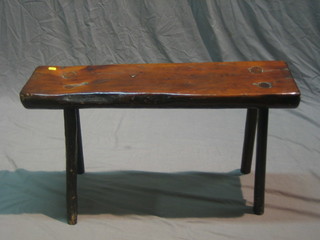 A rectangular rustic polished elm stool