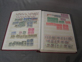 A large Schaubek red stock book containing GB Elizabeth II stamps etc