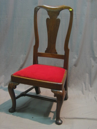 An 18th Century elm slat back carver chair with upholstered drop in seat, raised on cabriole supports united by an H framed stretcher (with old repair)