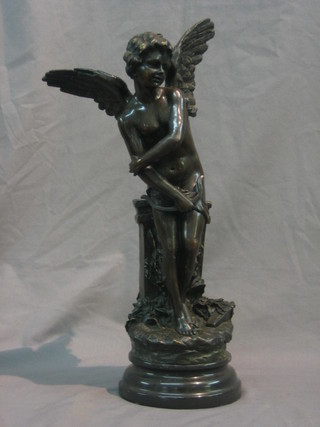A reproduction bronze figure of a standing Cupid, raised on a marble base 16"