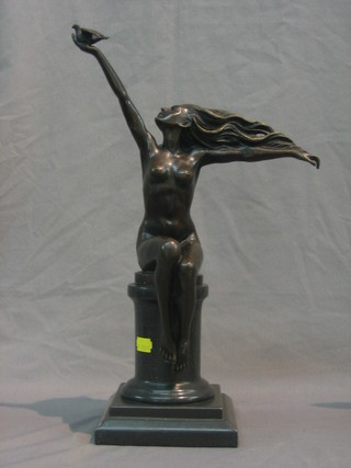A reproduction bronze figure of a standing naked lady, with arms outstretched holding a dove 17"