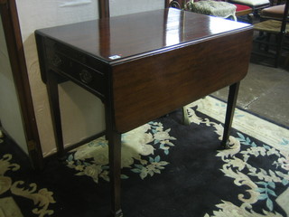 A Georgian mahogany Pembroke table fitted a brushing slide and drawer, raised on square tapering supports ending in castors 33"