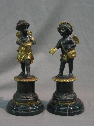 A pair of reproduction bronze figures of standing Cupids 11"