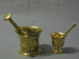 A bell shaped brass pestle 3" with mortar and 1 other pestle and mortar 4"