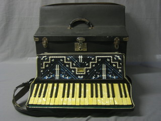 A Piano accordion with 120 buttons contained in a fibre carrying case