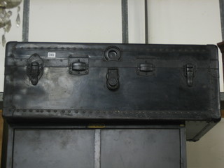 A black painted cabin trunk with hinged lid