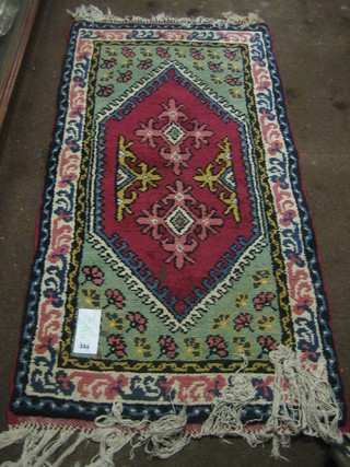 An Eastern pink ground rug with multi row borders 54" x 26"
